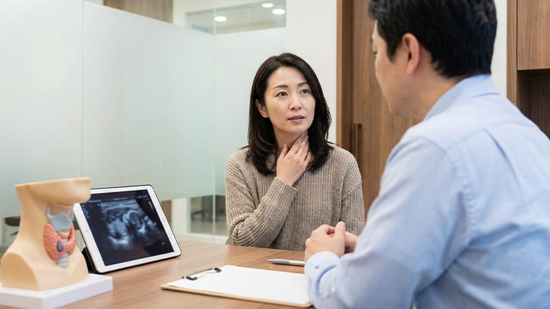 A thyroid patient having a medical consultation with a doctor at a hospital.