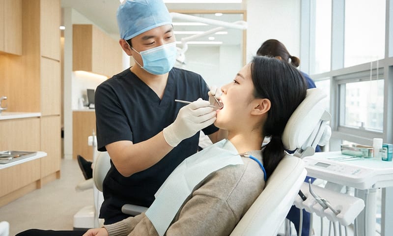 A patient receiving a dental scaling checkup at a clinic
